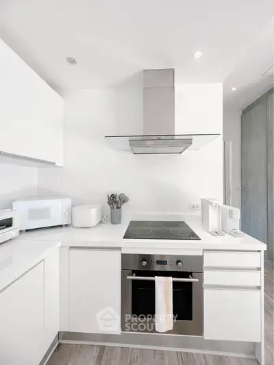 Modern kitchen with sleek white cabinets and built-in oven