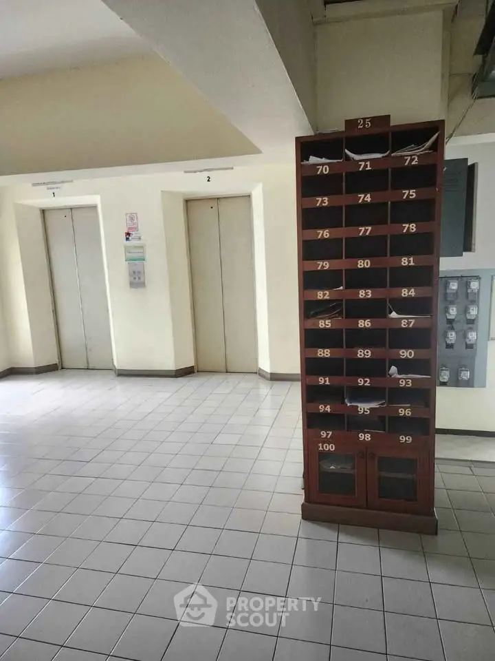 Spacious building lobby with elevators and mailboxes, ideal for modern living convenience.