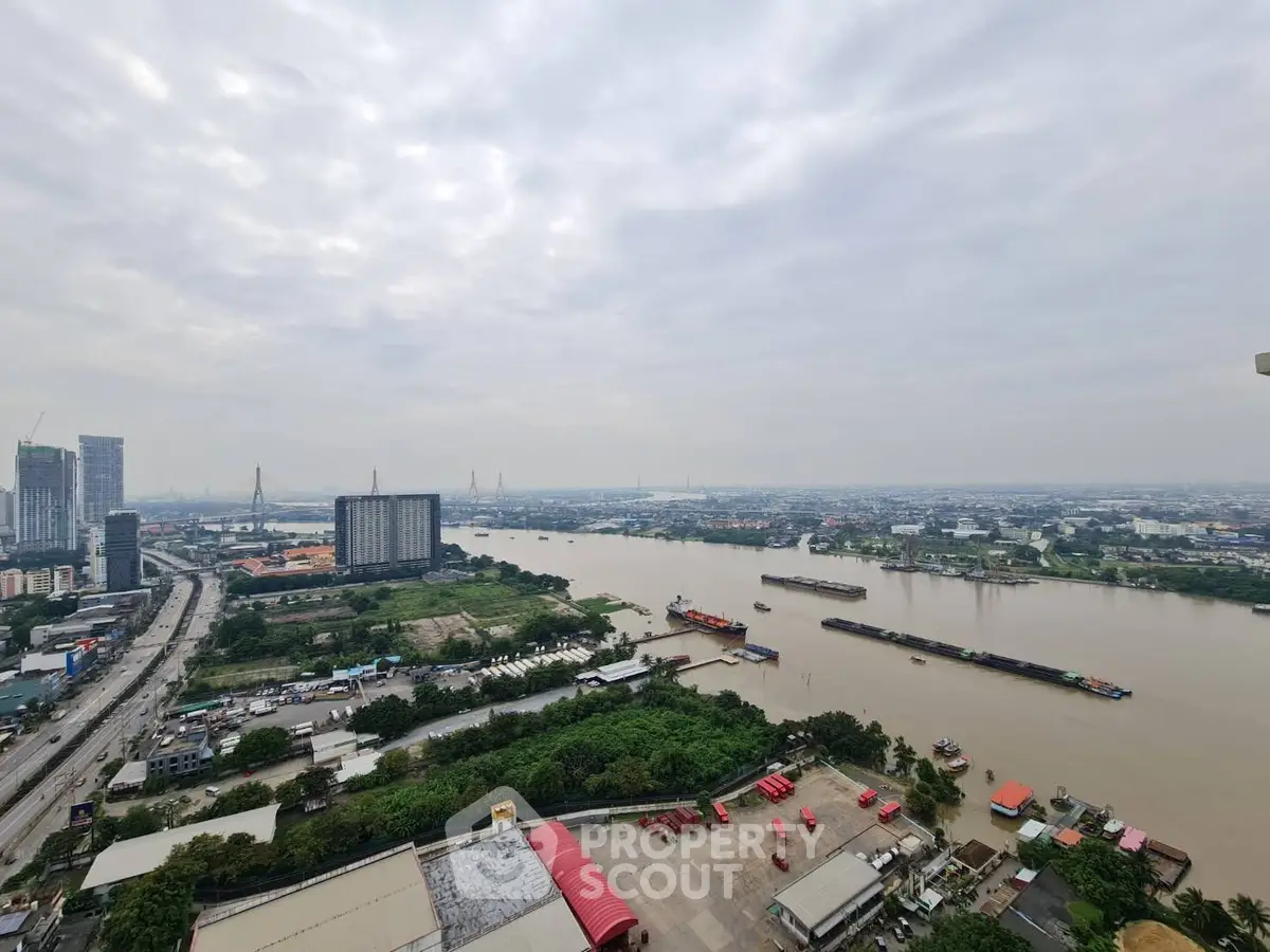 Stunning river view from high-rise building showcasing cityscape and lush greenery, perfect for urban living.