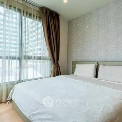 Modern bedroom with large window and elegant decor in a high-rise apartment.