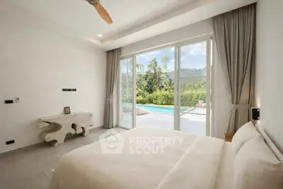 Luxurious bedroom with pool view and modern decor, featuring large sliding glass doors and elegant furnishings.
