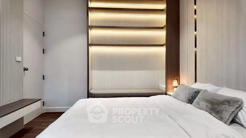 Luxurious modern bedroom with elegant lighting and plush bedding