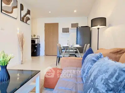 Modern living room with stylish decor and dining area in open layout apartment.