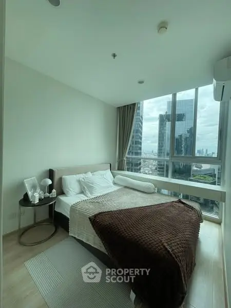 Modern bedroom with city view in high-rise apartment
