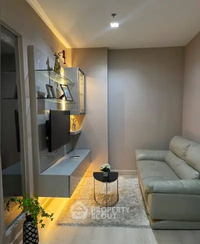Modern living room with sleek furniture and ambient lighting, perfect for cozy relaxation.
