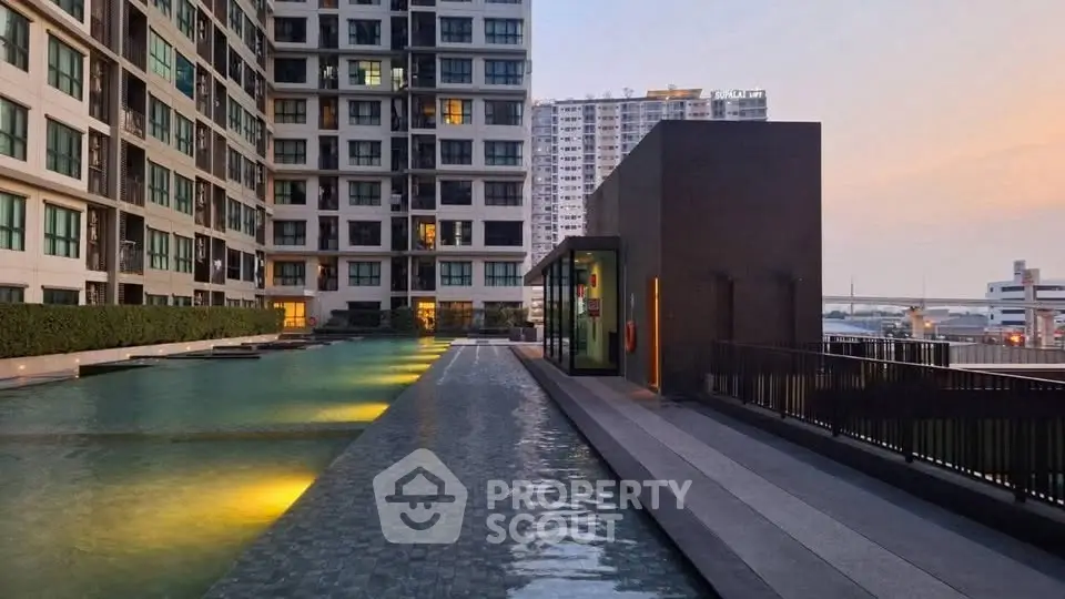 Luxurious condominium with stunning rooftop pool and city view at sunset.