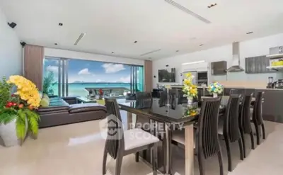 Luxurious open-plan living room with stunning ocean view and modern kitchen