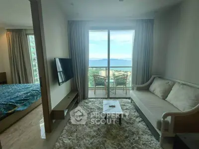Luxurious living room with stunning ocean view and cozy balcony