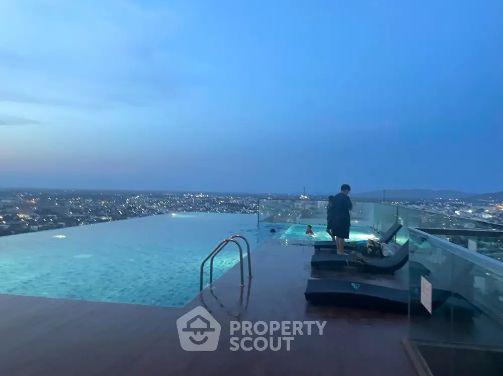 Stunning rooftop infinity pool with panoramic city views at dusk