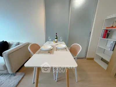 Modern dining area with stylish table setting and cozy seating in a contemporary apartment.