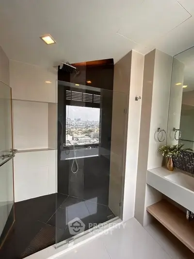 Luxurious bathroom with city view from glass shower enclosure