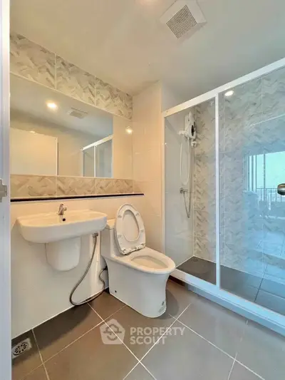 Modern bathroom with glass shower and stylish tile design