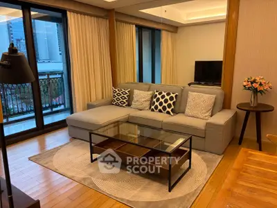 Luxurious living room with elegant decor and city view balcony access.