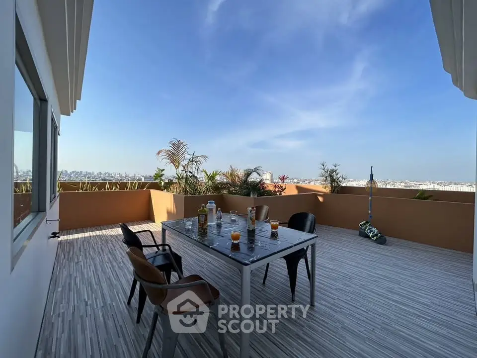 Stunning rooftop terrace with panoramic city views and modern outdoor seating.