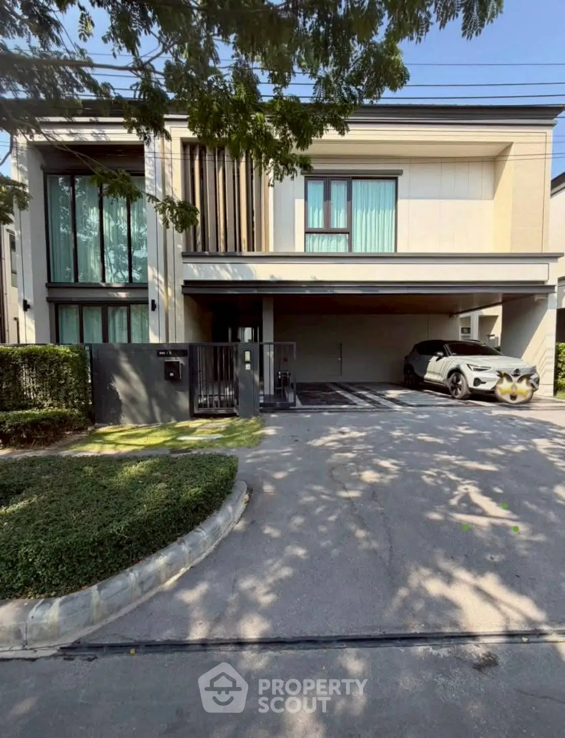 Modern two-story house with sleek design and spacious driveway in a serene neighborhood.