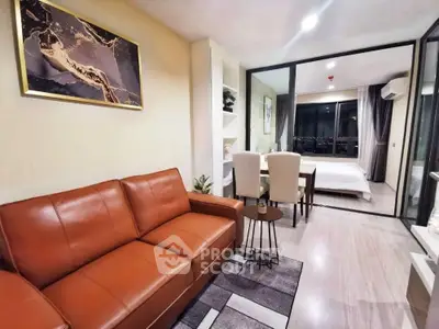 Modern open-plan living room with leather sofa and elegant dining area