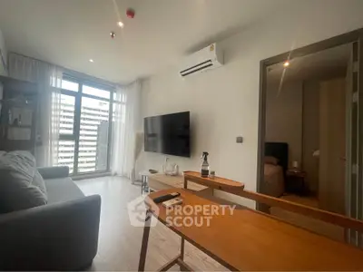 Modern living room with large window and stylish furniture in urban apartment.
