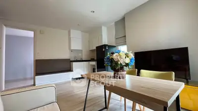 Modern open-plan living room with stylish dining area and contemporary kitchen.