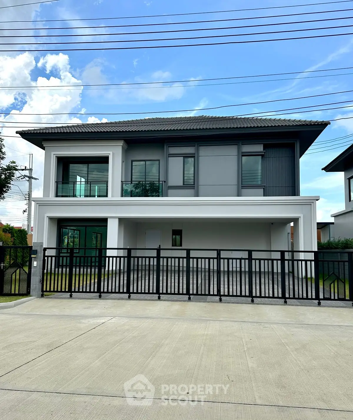 Modern two-story house with sleek design and spacious balcony, perfect for family living.