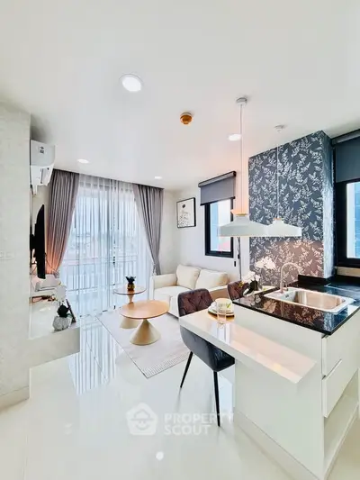 Modern open-layout living room with stylish kitchen and large windows in a high-rise apartment.