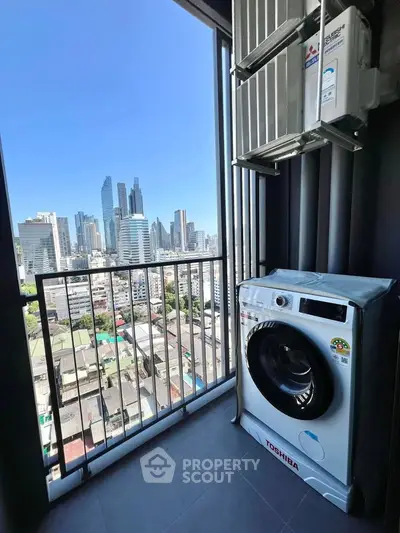 High-rise apartment balcony with city skyline view and washing machine.