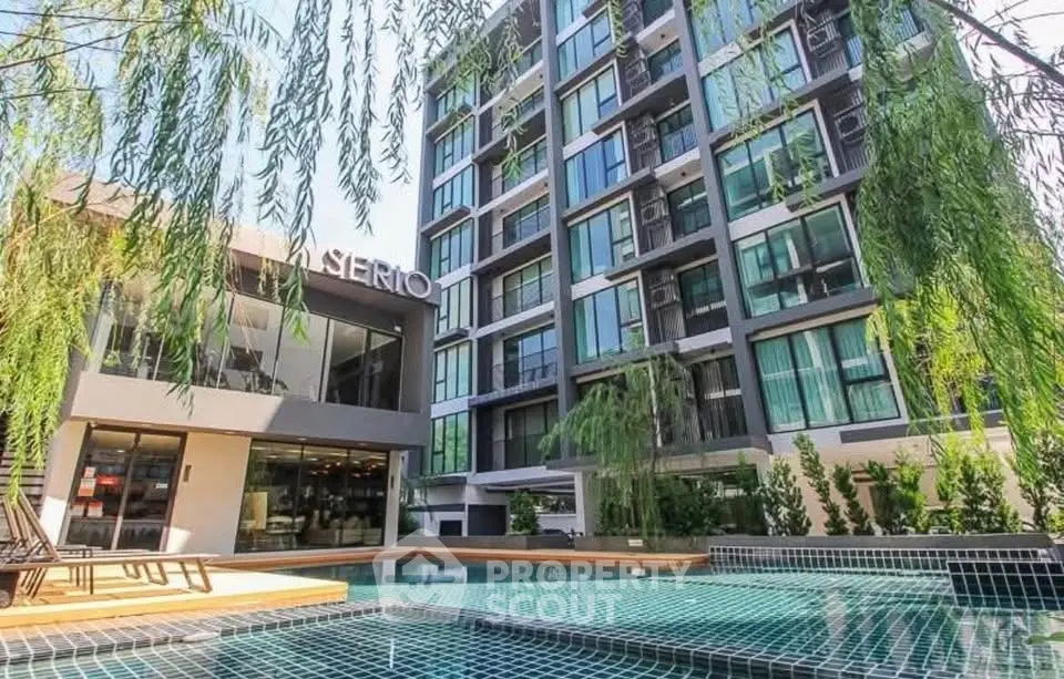 Modern condominium with pool and lush greenery in urban setting