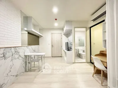 Modern apartment interior with open layout, featuring stylish marble accents and contemporary furniture.