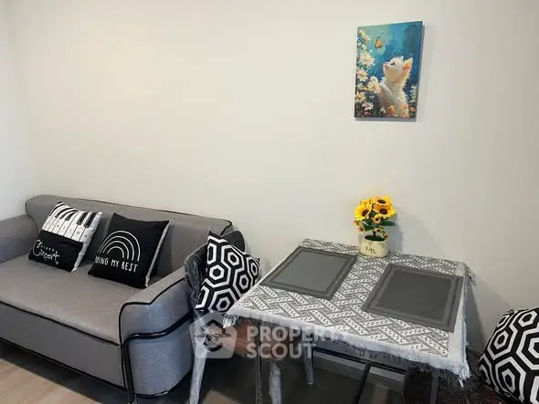 Cozy living room with stylish gray sofa and chic dining area, perfect for modern urban living.