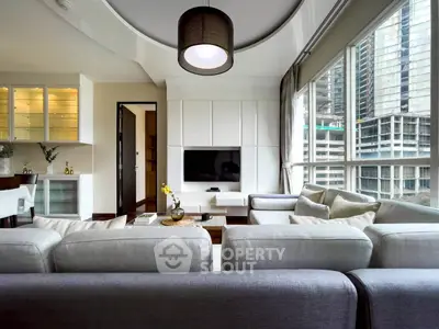 Luxurious modern living room with large windows and city view, featuring elegant furniture and stylish decor.