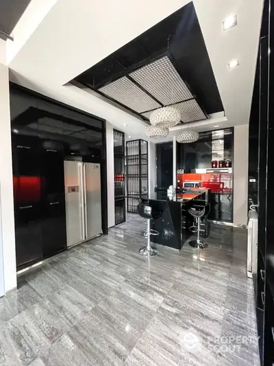 Modern kitchen with sleek black cabinetry and stainless steel appliances