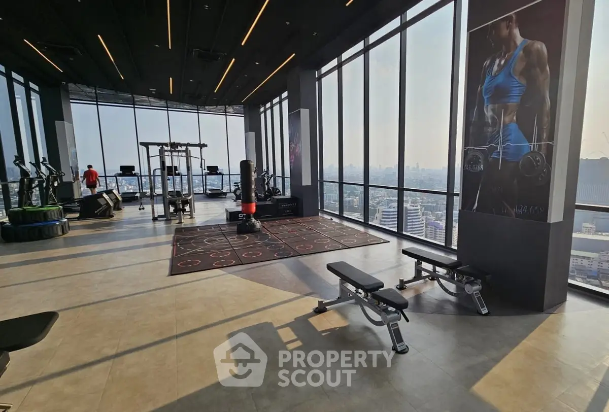 Spacious modern gym with panoramic city views and state-of-the-art equipment.