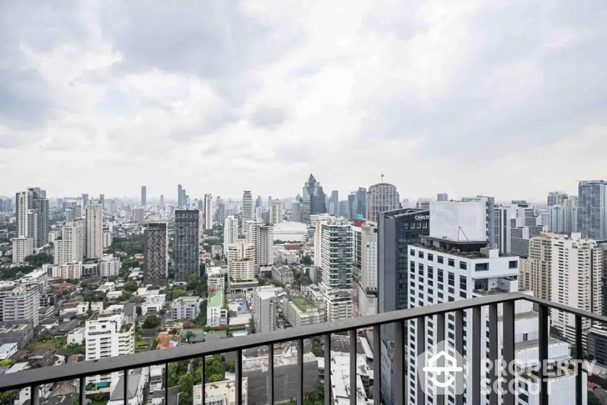 Stunning city skyline view from high-rise balcony in urban real estate setting.