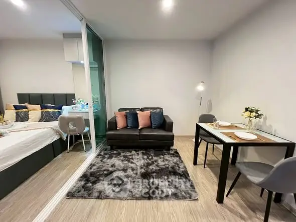 Modern studio apartment with cozy living area and dining space