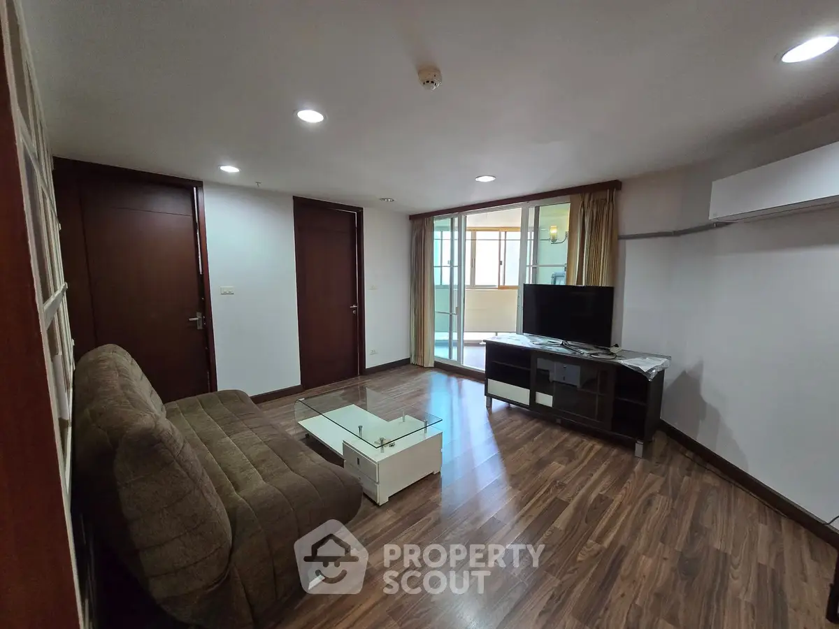 Spacious living room with modern decor and balcony access