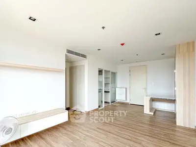 Spacious modern living room with wooden flooring and minimalist design