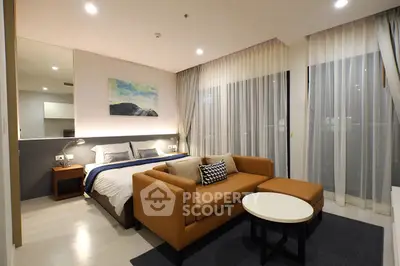 Modern studio apartment with cozy living area and stylish bedroom decor