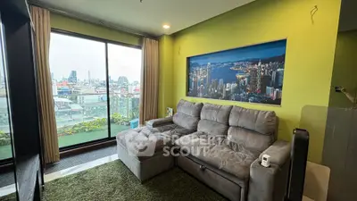 Modern living room with city view and cozy gray sofa