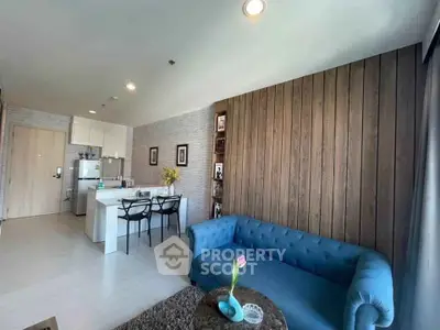 Modern living room with blue sofa and open kitchen layout