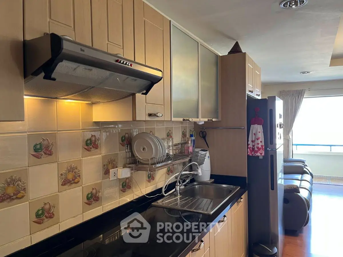 Charming kitchen with modern appliances and cozy living room view