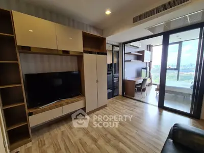 Modern living room with wooden flooring and large windows offering city views