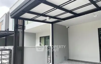 Modern residential building exterior with sleek design and spacious balcony area.