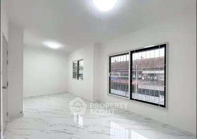 Spacious and bright living room with large windows and modern flooring