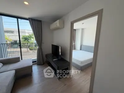 Modern apartment living room with balcony and bedroom view