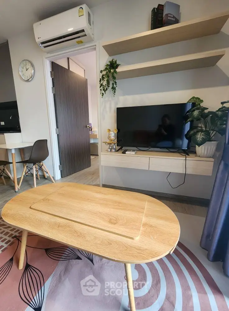 Modern living room with wooden furniture and wall-mounted TV, featuring stylish decor.