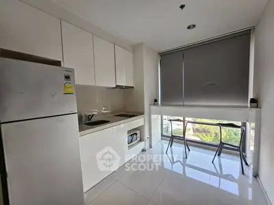 Modern kitchen with sleek cabinets and large window view