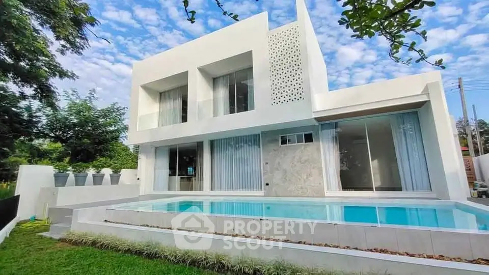 Stunning modern white villa with private pool and lush garden, perfect for luxury living.