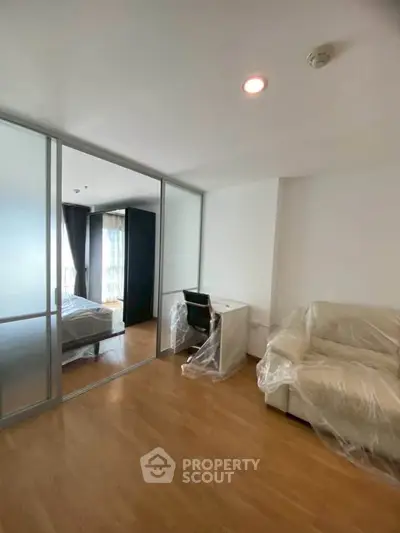 Modern apartment with sliding glass doors, cozy living area, and natural light.