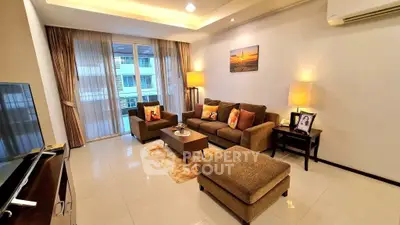 Spacious living room with modern decor and large windows in a luxury apartment.