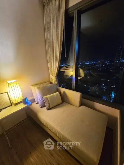 Cozy living room corner with night city view and elegant lighting