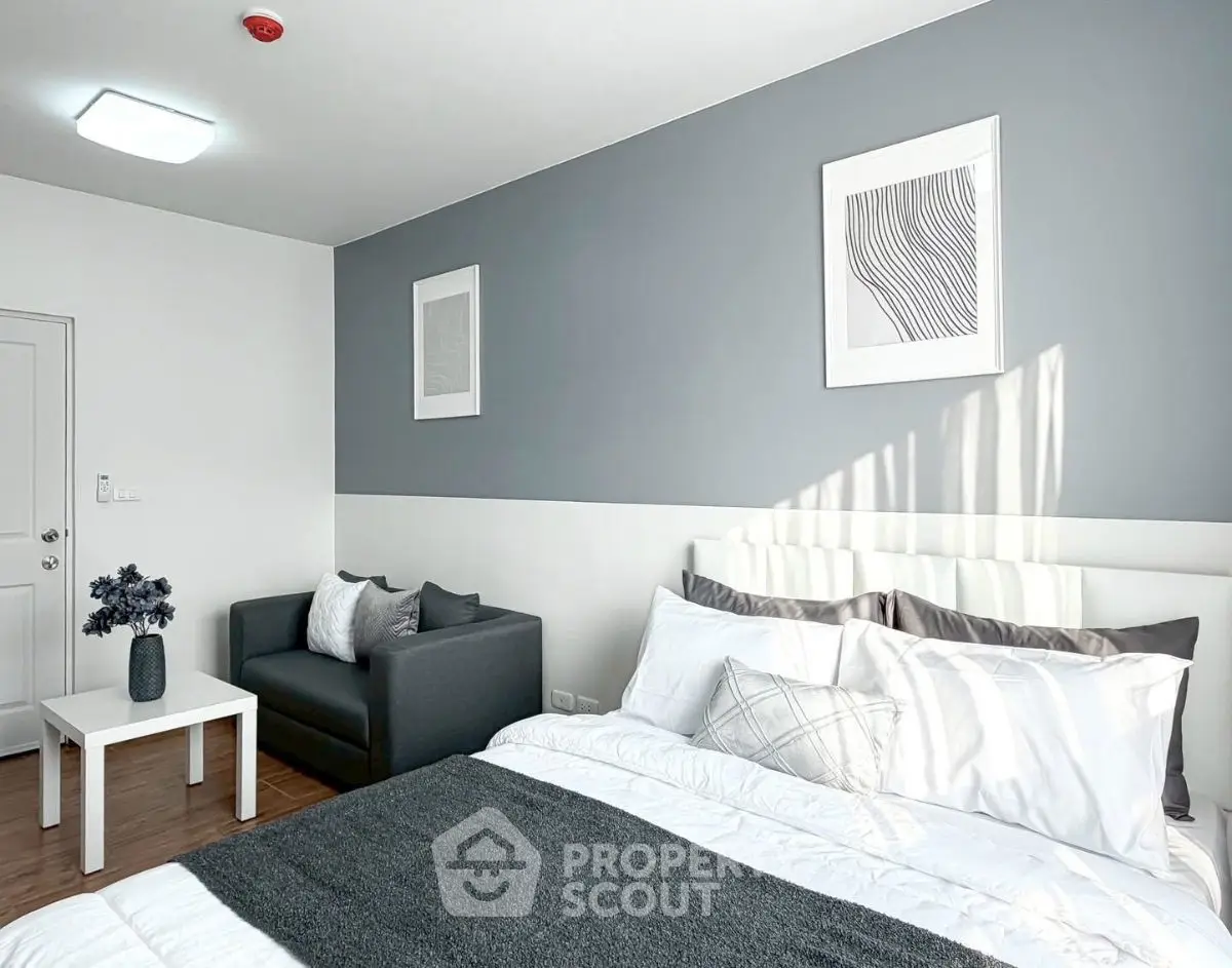 Modern bedroom with stylish decor and cozy seating area